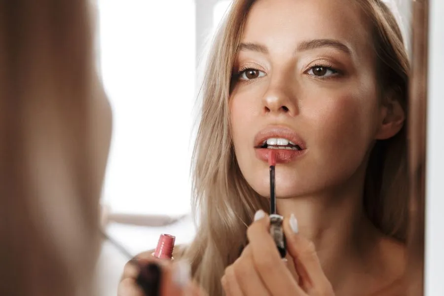woman applying lipstick